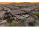 Aerial view of the backyard oasis with outdoor kitchen, pool and manicured landscaping at 31705 N 128Th Dr, Peoria, AZ 85383