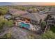 Aerial view of backyard showcasing pool, patio, and desert landscaping with mountain views at 31705 N 128Th Dr, Peoria, AZ 85383