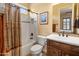 Well-lit bathroom with a tiled shower/tub combo, warm color scheme, and coordinated fixtures at 31705 N 128Th Dr, Peoria, AZ 85383