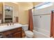 Bathroom featuring a tiled shower/tub combo, wood vanity, and neutral color scheme at 31705 N 128Th Dr, Peoria, AZ 85383