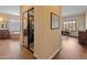 Hallway view into a luxurious bathroom with double vanities, a soaking tub and a walk-in closet at 31705 N 128Th Dr, Peoria, AZ 85383