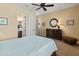 Comfortable bedroom featuring neutral decor, plush carpeting, and ensuite bathroom access at 31705 N 128Th Dr, Peoria, AZ 85383