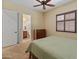 Inviting bedroom featuring neutral decor, plush carpeting, and a view to the ensuite bathroom at 31705 N 128Th Dr, Peoria, AZ 85383