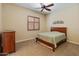 Cozy bedroom with neutral tones, plantation shutters, ceiling fan, and comfortable furnishings at 31705 N 128Th Dr, Peoria, AZ 85383