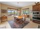 Cozy dining area with a view is bathed in natural light, creating an inviting and comfortable atmosphere at 31705 N 128Th Dr, Peoria, AZ 85383