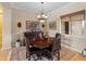 Charming dining room features dark wood furniture, a decorative chandelier, and cozy space for Gathering meals at 31705 N 128Th Dr, Peoria, AZ 85383