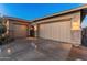 Two car garages with stone trim and an iron gate add curb appeal to this lovely home at 31705 N 128Th Dr, Peoria, AZ 85383