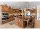 Gourmet kitchen with large island, custom cabinets and stainless steel appliances at 31705 N 128Th Dr, Peoria, AZ 85383