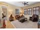 Comfortable living room with leather furniture, plantation shutters, and traditional decor and furnishings at 31705 N 128Th Dr, Peoria, AZ 85383