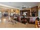 Inviting living room features a stone fireplace, comfortable seating, and a seamless flow to the dining area at 31705 N 128Th Dr, Peoria, AZ 85383