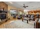 Relaxing living room with a stone fireplace is perfect for unwinding while enjoying seamless access to the gourmet kitchen at 31705 N 128Th Dr, Peoria, AZ 85383