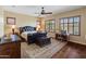 Bedroom with neutral walls, wood floors, ceiling fan, and natural light at 31705 N 128Th Dr, Peoria, AZ 85383