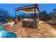 Outdoor kitchen featuring a built-in grill, stone accents and a pergola, perfect for entertaining at 31705 N 128Th Dr, Peoria, AZ 85383