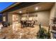 Covered patio with a dining area, offering a seamless indoor-outdoor living experience with desert landscaping at 31705 N 128Th Dr, Peoria, AZ 85383