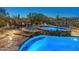 Cozy backyard spa adjacent to a sparkling pool and lounge area, ideal for relaxing evenings under the stars at 31705 N 128Th Dr, Peoria, AZ 85383