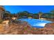 Stunning backyard pool and spa featuring ample seating, desert landscaping, and serene mountain views at 31705 N 128Th Dr, Peoria, AZ 85383