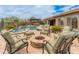 Beautiful backyard with pool, spa, fire pit, outdoor seating and pergola covered barbeque provides relaxation and entertainment at 31705 N 128Th Dr, Peoria, AZ 85383