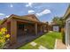 Backyard view highlighting the covered patio and mature landscaping at 3248 W Sunshine Butte Dr, San Tan Valley, AZ 85144