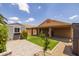 Landscaped backyard featuring a shed, covered patio, green grass and vibrant flowers at 3248 W Sunshine Butte Dr, San Tan Valley, AZ 85144