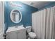 Inviting bathroom featuring a blue accent wall, white vanity, and toilet at 3248 W Sunshine Butte Dr, San Tan Valley, AZ 85144