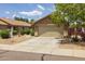 Exterior view of tan single story home with tile roof, desert landscaping, and attached two-car garage at 3248 W Sunshine Butte Dr, San Tan Valley, AZ 85144