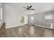 Open living room space features wood-look flooring, neutral walls, and a ceiling fan at 3248 W Sunshine Butte Dr, San Tan Valley, AZ 85144