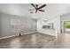 Open living space featuring neutral colored walls, wood-look flooring, and a view of the kitchen at 3248 W Sunshine Butte Dr, San Tan Valley, AZ 85144