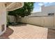 Charming backyard featuring a paved patio, mature trees, and a tranquil fountain at 33 W Missouri Ave # 17, Phoenix, AZ 85013