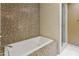 Elegant bathroom with a soaking tub, shower stall and decorative tiling at 33 W Missouri Ave # 17, Phoenix, AZ 85013