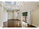 Bright bedroom with vaulted ceilings, hardwood floors, and sliding glass doors to the balcony at 33 W Missouri Ave # 17, Phoenix, AZ 85013