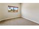 Bright bedroom with carpet floors, neutral paint and a view of lush landscape at 33 W Missouri Ave # 17, Phoenix, AZ 85013
