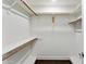 Walk-in closet features ample storage with wooden rods and shelving throughout at 33 W Missouri Ave # 17, Phoenix, AZ 85013