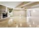 Spacious living room features a cozy fireplace and French doors to the outdoor patio at 33 W Missouri Ave # 17, Phoenix, AZ 85013