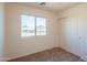Standard bedroom with a carpeted floor, double door closet, and a window at 3365 N Sunaire --, Mesa, AZ 85215