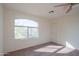 Spacious bedroom featuring neutral carpeting and a ceiling fan at 3365 N Sunaire --, Mesa, AZ 85215