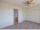 Standard carpeted bedroom featuring a ceiling fan and ensuite bathroom at 3365 N Sunaire --, Mesa, AZ 85215