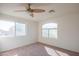 Well-lit bedroom with large windows and a ceiling fan for added comfort at 3365 N Sunaire --, Mesa, AZ 85215