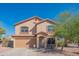 Two-story home featuring a 2-car garage, neutral stucco, and low-maintenance desert landscaping under a bright blue sky at 3365 N Sunaire --, Mesa, AZ 85215