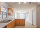 Well-lit kitchen with tile flooring, light wood cabinets and a dual basin sink at 3365 N Sunaire --, Mesa, AZ 85215