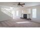 Bright living room is accentuated by a skylight, large windows, a fireplace, and a staircase at 3365 N Sunaire --, Mesa, AZ 85215