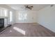 Spacious living room features a ceiling fan, fireplace, and door to the entrance at 3365 N Sunaire --, Mesa, AZ 85215