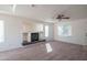 Sun-filled living room features a ceiling fan, a fireplace, and plenty of space for entertaining guests or relaxing at 3365 N Sunaire --, Mesa, AZ 85215