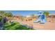 Blue playground structure is on a sand lot in the community park with views of surrounding homes and a walking path at 3365 N Sunaire --, Mesa, AZ 85215