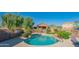 Community swimming pool is surrounded by desert landscaping and a safety fence, perfect for Gathering fun and relaxation at 3365 N Sunaire --, Mesa, AZ 85215