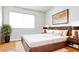 The staged bedroom features a bed, side tables, and decor for a modern aesthetic at 3556 W Augusta Ave, Phoenix, AZ 85051