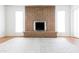 Empty living room featuring a brick fireplace with modern decor at 3556 W Augusta Ave, Phoenix, AZ 85051