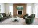 Inviting living room with a brick fireplace, green sofa, and soft carpet at 3556 W Augusta Ave, Phoenix, AZ 85051