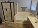 Bathroom featuring a combined tub and shower, a single sink, and warm beige tones at 36119 W Catalan St, Maricopa, AZ 85138