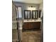 Bathroom with a double sink vanity, a walk-in shower, and warm beige tones at 36119 W Catalan St, Maricopa, AZ 85138