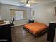 Bedroom featuring laminate flooring, a bed, and a ceiling fan at 36119 W Catalan St, Maricopa, AZ 85138